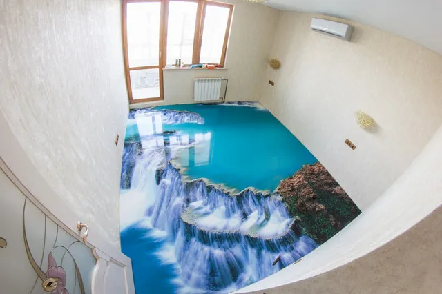 Room floor printed with a 3D waterfall and lagoon scene